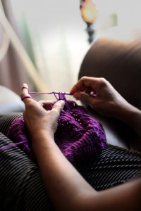 Picture of a women knitting wool